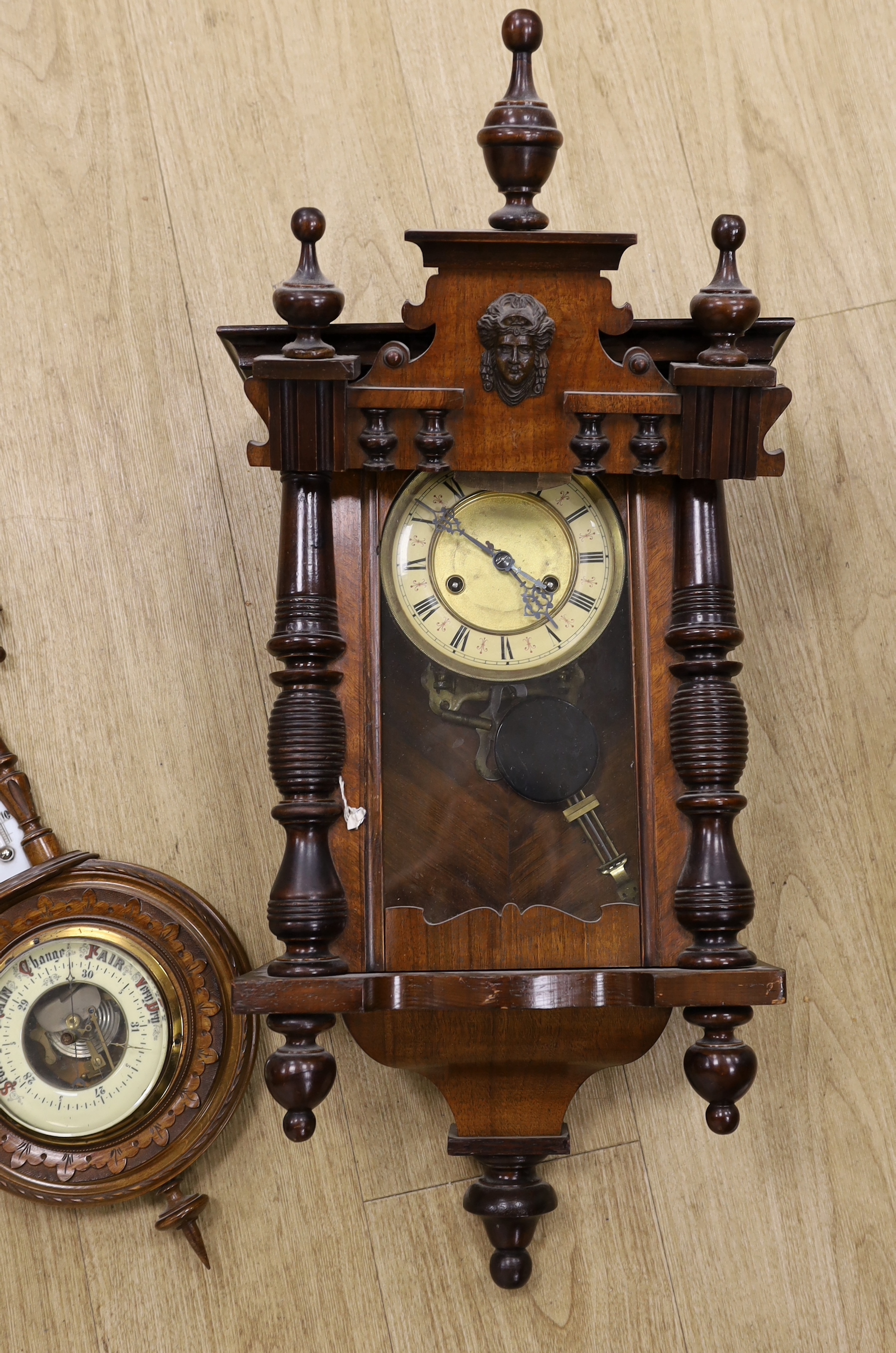 A mahogany Vienna wall clock and an aneroid barometer